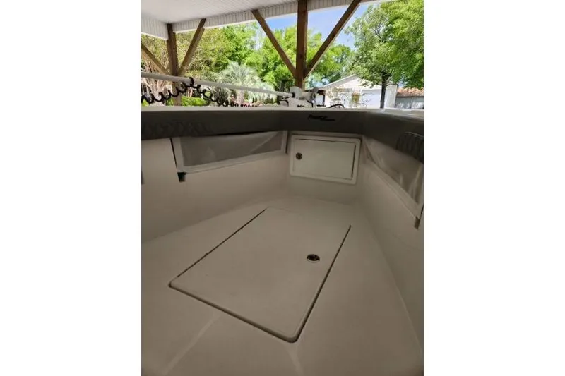 Slide: The Image of 2023 Front Runner 36 cc boat interior under a canopy with lush greenery. - 19