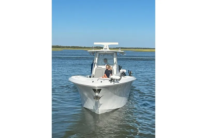 Slide: The Image of 2023 Front Runner 36 cc boat on calm water with clear blue sky. - 2