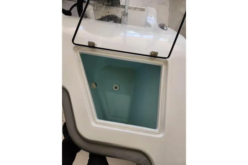 Slide: The Image of 2023 Front Runner 36 cc boat livewell with open lid, showcasing interior design. - 7