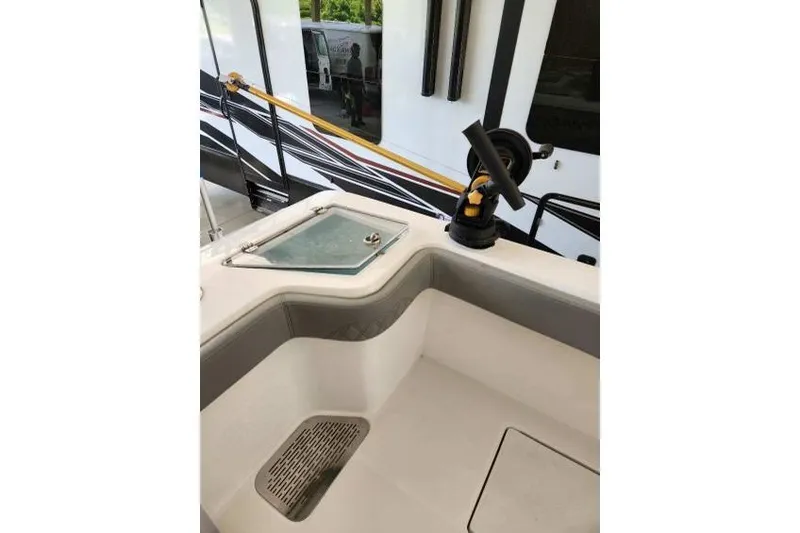 Slide: The Image of 2023 Front Runner 36 cc boat interior with rod holder and storage compartment. - 8