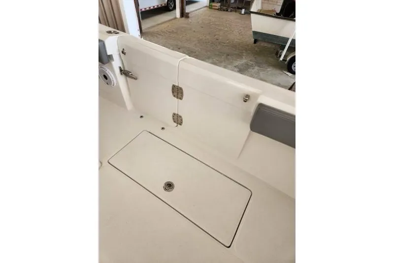 Slide: The Image of 2023 Front Runner 36 cc boat interior with storage compartment and hinges. - 9