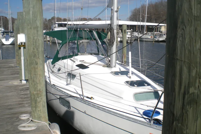 Slide: The Image of 1997 Beneteau Oceanis 321 sailboat docked at marina, featuring green canopy. - 2