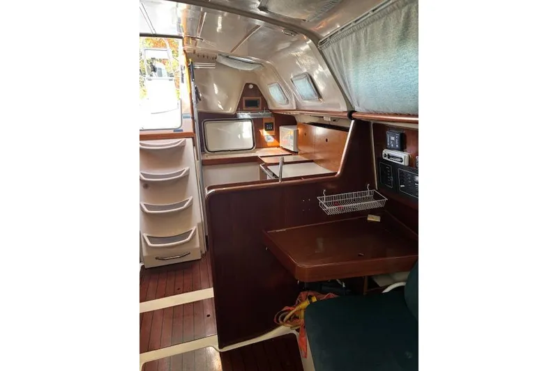Slide: The Image of Interior of 1997 Beneteau Oceanis 321 sailboat with wood finish and compact kitchen area. - 21