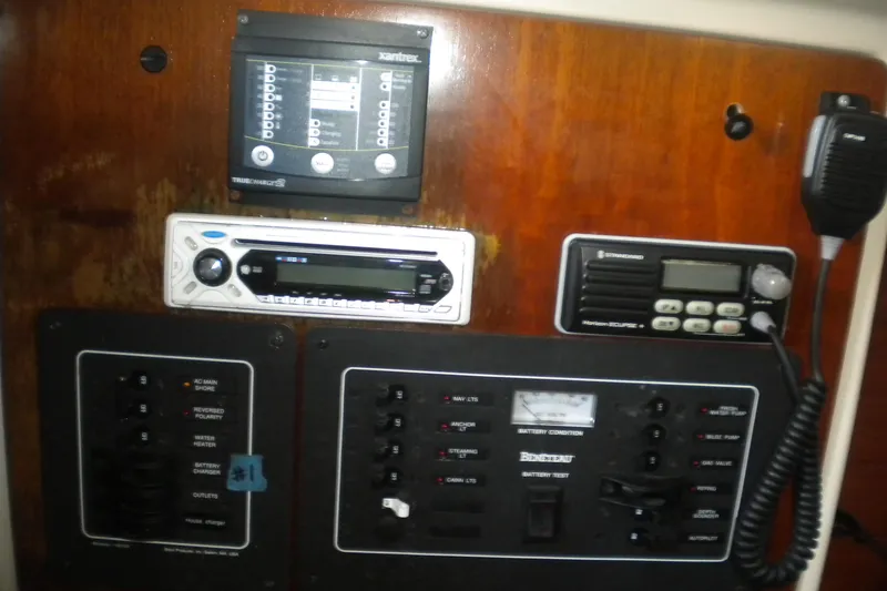 Slide: The Image of Control panel of a 1997 Beneteau Oceanis 321 sailboat with radio and battery indicators. - 25