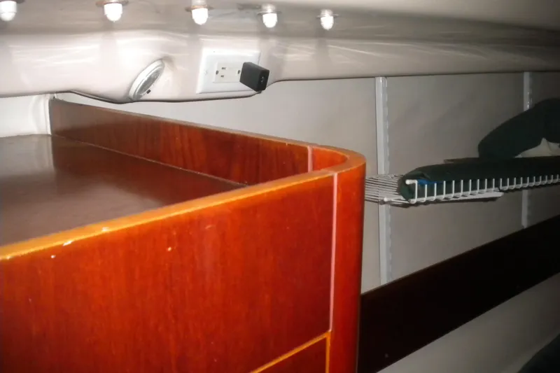 Slide: The Image of Interior of 1997 Beneteau Oceanis 321 yacht, featuring wooden cabinetry and shelving. - 27