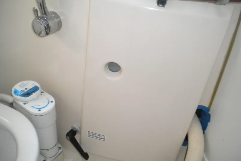 Slide: The Image of Beneteau Oceanis 321 (1997) yacht bathroom with marine toilet and plumbing fixtures. - 29