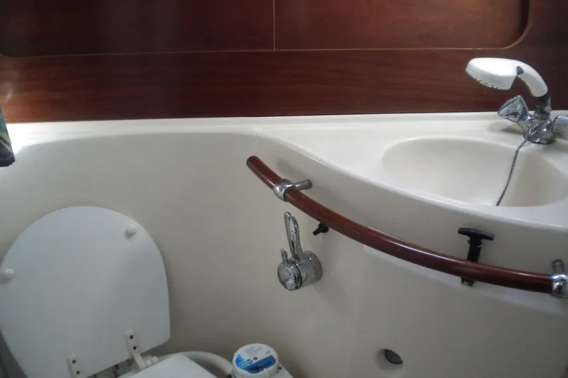 Slide: The Image of Bathroom interior of 1997 Beneteau Oceanis 321 yacht, featuring sink and toilet. - 30