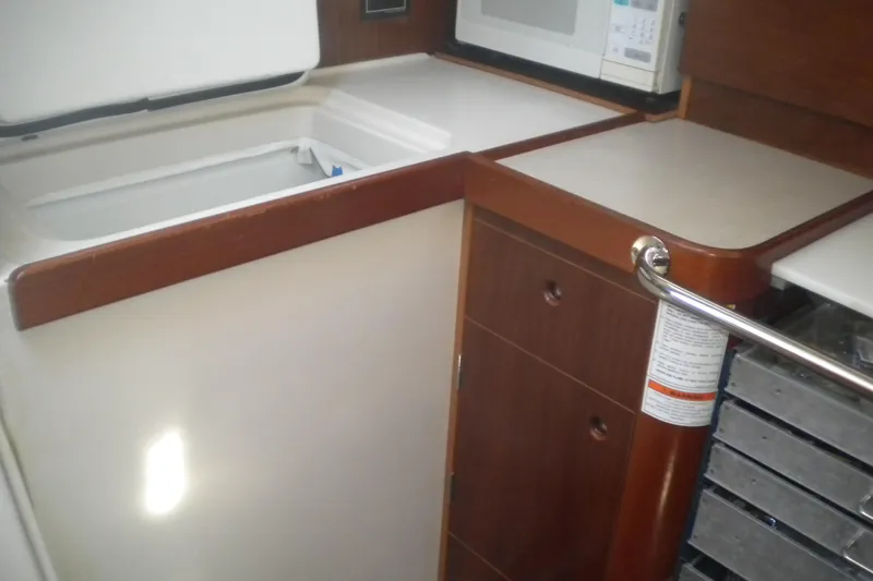Slide: The Image of Galley area of 1997 Beneteau Oceanis 321 sailboat with microwave and storage. - 35