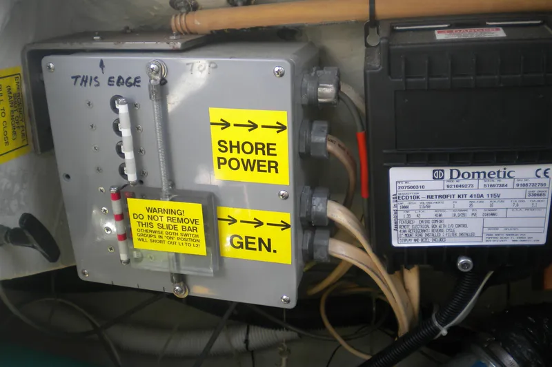 Slide: The Image of Electrical panel on a 1997 Beneteau Oceanis 321 sailboat with shore power and generator connections. - 38