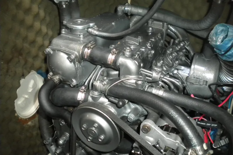 Slide: The Image of Engine of a 1997 Beneteau Oceanis 321 sailboat, showcasing detailed components and hoses. - 40