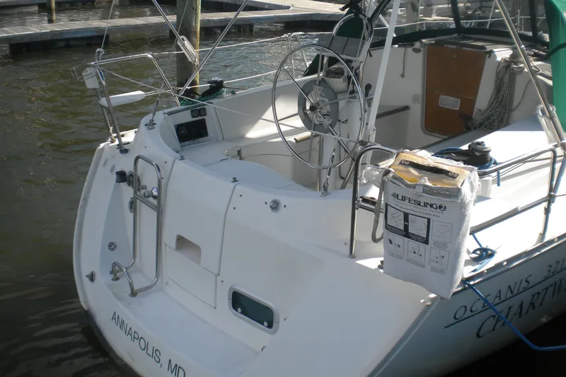 Slide: The Image of 1997 Beneteau Oceanis 321 sailboat docked in Annapolis, MD, featuring a spacious cockpit. - 7