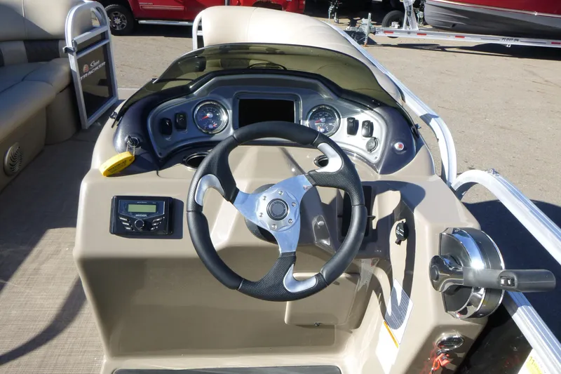 Slide: The Image of 2022 Sun Tracker Party Barge 22 DLX dashboard with steering wheel and controls. - 11