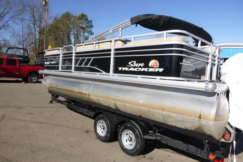 Slide: The Image of 2022 Sun Tracker Party Barge 22 DLX pontoon boat on trailer, parked outdoors. - 3
