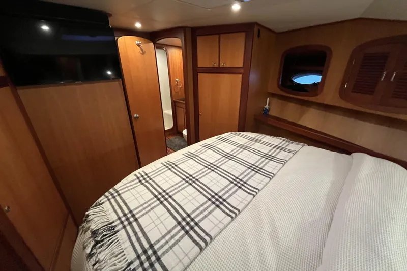 Slide: The Image of Luxurious cabin interior of 2010 Mikelson 43 Sportfisher yacht with cozy bedding. - 12