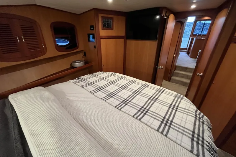 Slide: The Image of Luxurious cabin interior of 2010 Mikelson 43 Sportfisher yacht with cozy bedding. - 13