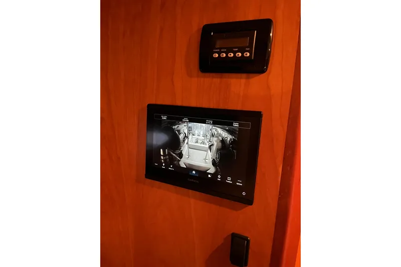 Slide: The Image of Control panel and display screen inside 2010 Mikelson 43 Sportfisher yacht. - 14