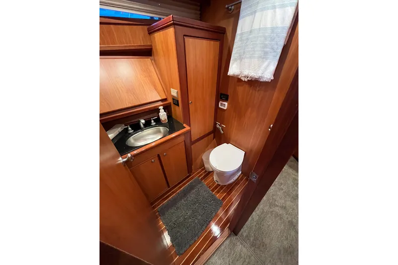 Slide: The Image of Luxurious bathroom in 2010 Mikelson 43 Sportfisher yacht with wood finish and modern amenities. - 15