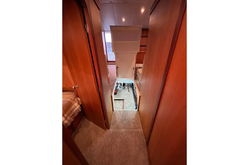 Slide: The Image of Interior view of 2010 Mikelson 43 Sportfisher yacht, featuring hallway and cabin access. - 19