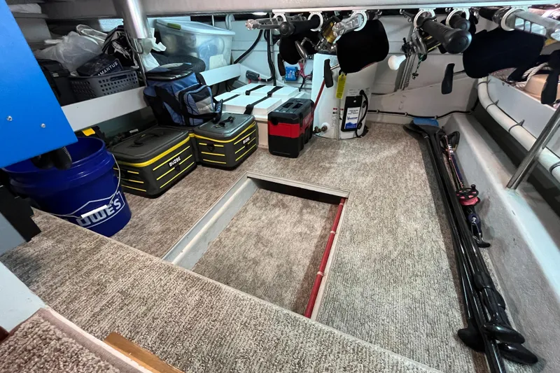 Slide: The Image of Interior of 2010 Mikelson 43 Sportfisher with fishing gear and storage compartments. - 20