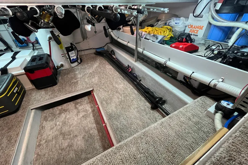 Slide: The Image of Interior of a 2010 Mikelson 43 Sportfisher boat with fishing gear and storage. - 21