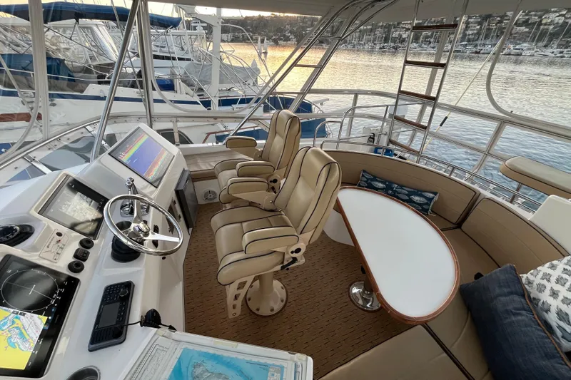 Slide: The Image of Luxurious 2010 Mikelson 43 Sportfisher yacht interior with helm, seating, and navigation equipment. - 29