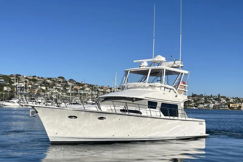 Slide: The Image of 2010 Mikelson 43 Sportfisher yacht on calm water, clear blue sky background. - 3