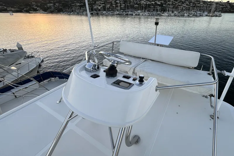 Slide: The Image of Flybridge of 2010 Mikelson 43 Sportfisher overlooking marina at sunset. - 31