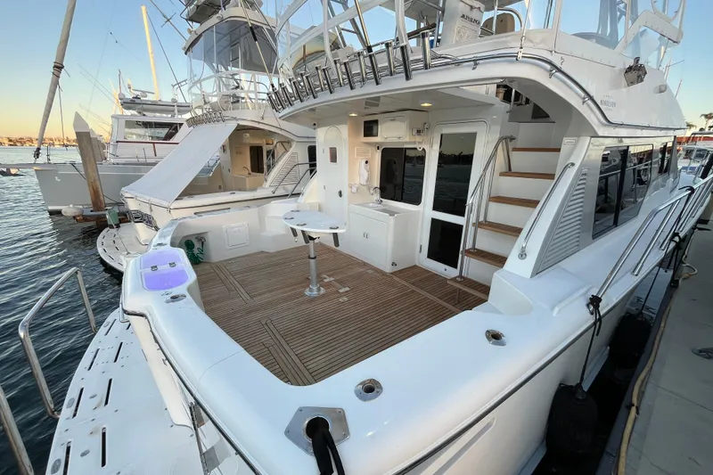 Slide: The Image of 2010 Mikelson 43 Sportfisher yacht docked, featuring spacious deck and modern amenities. - 33