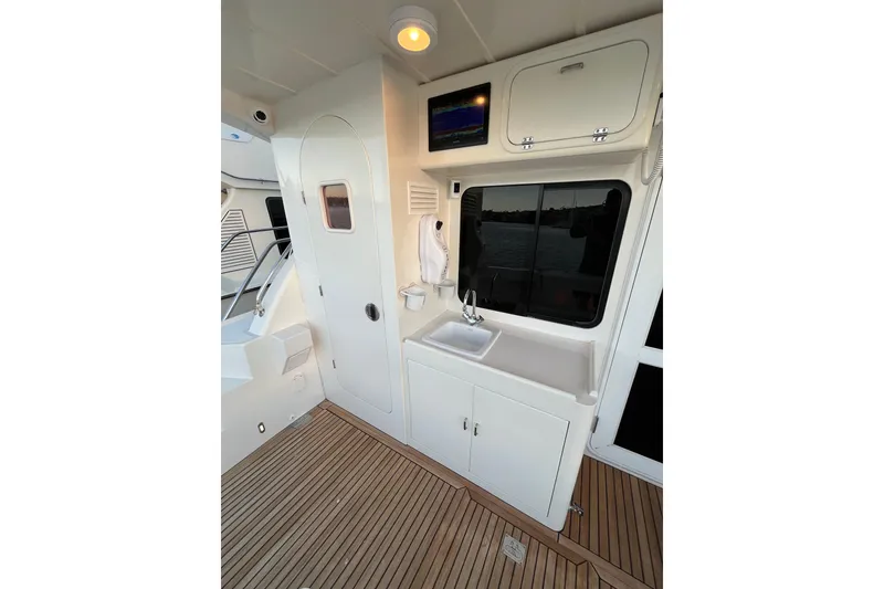Slide: The Image of Interior of 2010 Mikelson 43 Sportfisher yacht with sink and storage cabinets. - 36