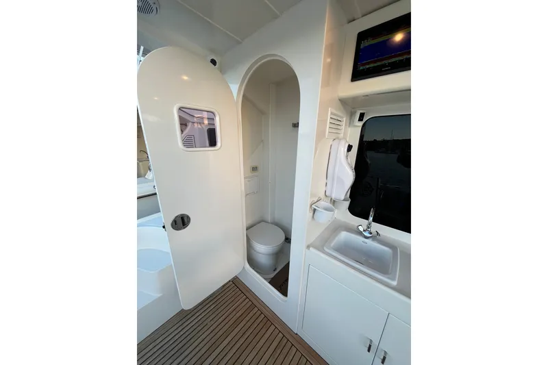 Slide: The Image of Interior of 2010 Mikelson 43 Sportfisher yacht bathroom with sink and toilet. - 37