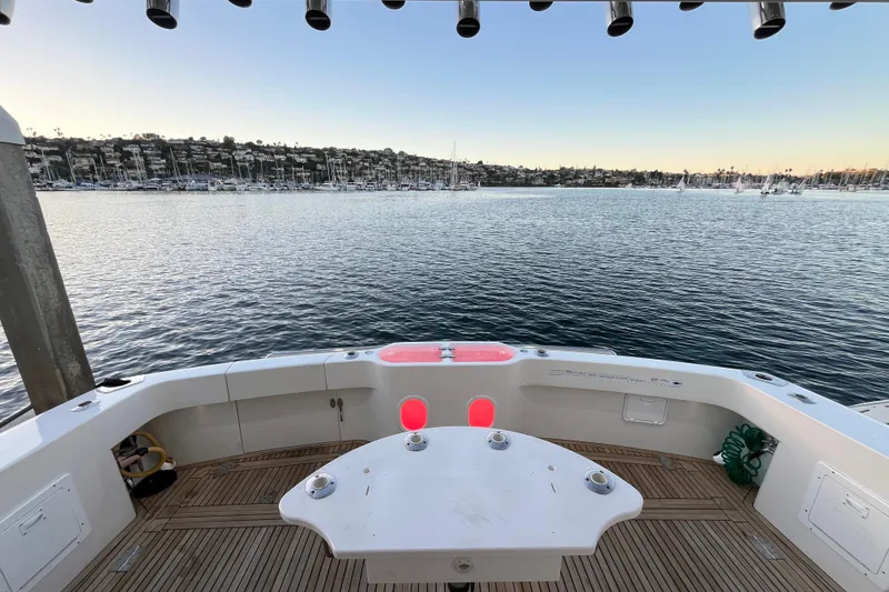 Slide: The Image of 2010 Mikelson 43 Sportfisher boat deck overlooking a serene marina at sunset. - 39