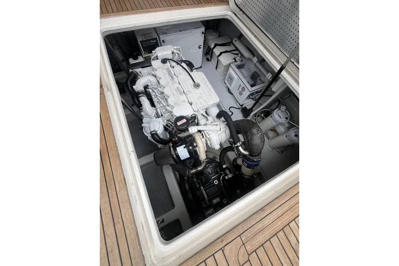 Slide: The Image of Engine compartment of 2010 Mikelson 43 Sportfisher, showcasing detailed mechanical components. - 43