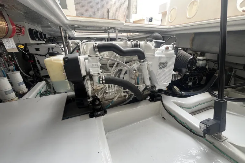 Slide: The Image of Engine room of 2010 Mikelson 43 Sportfisher, showcasing detailed mechanical components. - 44
