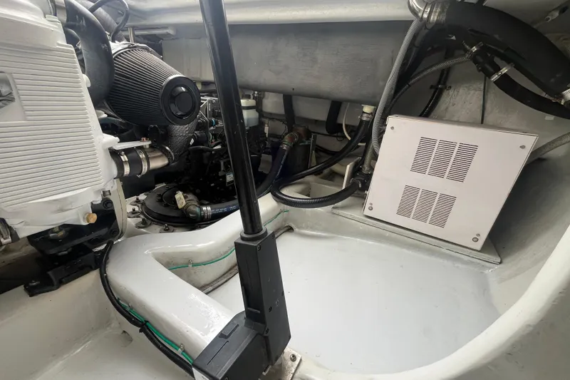 Slide: The Image of Engine compartment of a 2010 Mikelson 43 Sportfisher boat, showcasing mechanical components. - 46