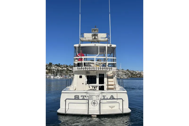 Slide: The Image of 2010 Mikelson 43 Sportfisher yacht "Stella" on calm water, clear blue sky background. - 5