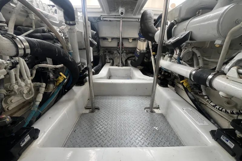 Slide: The Image of Engine room of 2010 Mikelson 43 Sportfisher, showcasing mechanical components and piping. - 50