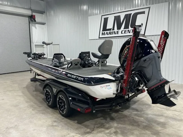 Slide: The Image of 2022 Skeeter FXR21 Apex boat in showroom, featuring sleek design and powerful engine. - 10