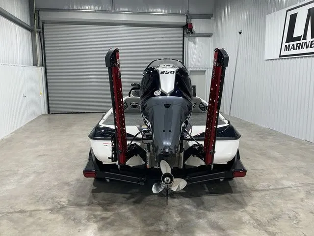 Slide: The Image of 2022 Skeeter FXR21 Apex boat in garage, rear view with powerful outboard motor. - 11