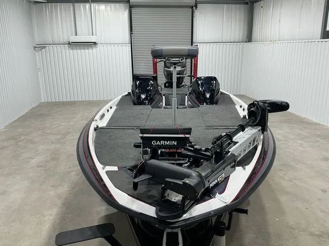 Slide: The Image of 2022 Skeeter FXR21 Apex bass boat with Garmin and Minn Kota equipment in a garage. - 12