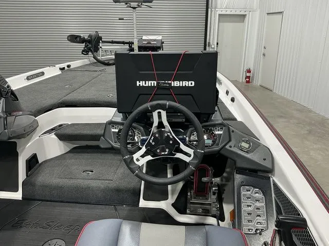 Slide: The Image of 2022 Skeeter FXR21 Apex boat dashboard with Humminbird electronics and steering wheel. - 15