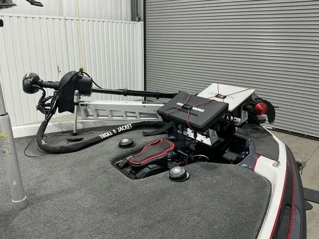 Slide: The Image of 2022 Skeeter FXR21 Apex boat with advanced trolling motor and equipment in a garage setting. - 5