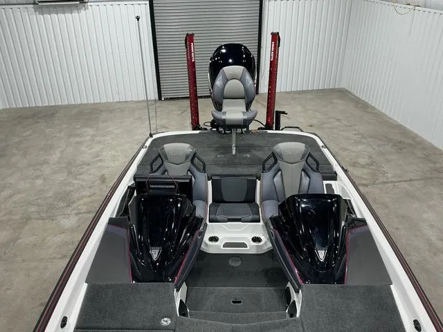 Slide: The Image of 2022 Skeeter FXR21 Apex boat interior with dual consoles and seating in a garage setting. - 7