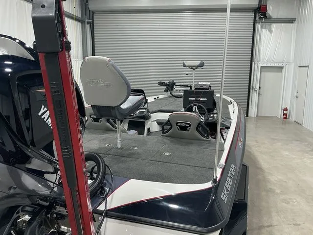 Slide: The Image of 2022 Skeeter FXR21 Apex boat in a garage, featuring Yamaha engine and fishing seats. - 9