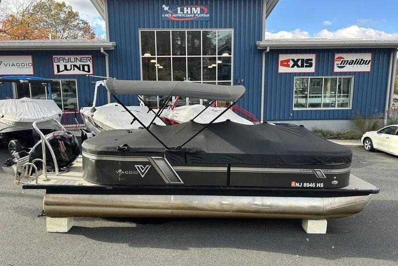 Slide: The Image of 2023 Viaggio L22U pontoon boat with cover at dealership, featuring sleek design and modern amenities. - 10