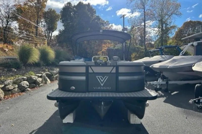 Slide: The Image of 2023 Viaggio L22U pontoon boat with Mercury engine, parked outdoors near dealership. - 3