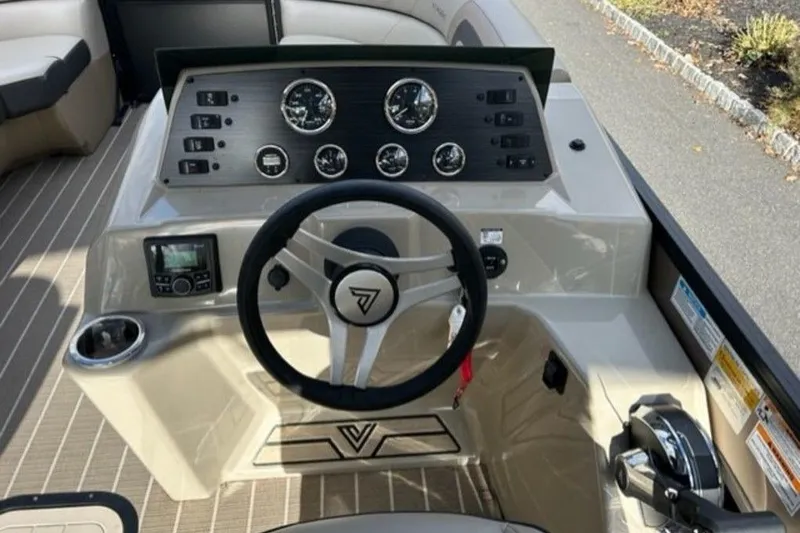 Slide: The Image of 2023 Viaggio L22U pontoon boat parked outdoors on a sunny day. - 6