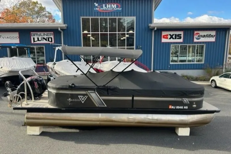 Slide: The Image of 2023 Viaggio L22U pontoon boat interior with plush seating and modern dashboard. - 8