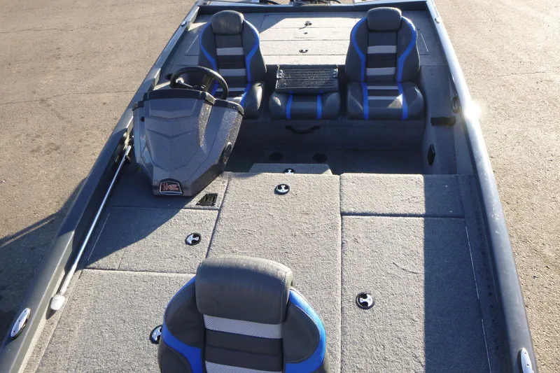 Slide: The Image of 2022 Ranger RT188P boat interior with gray and blue seating, steering console, and spacious deck. - 5