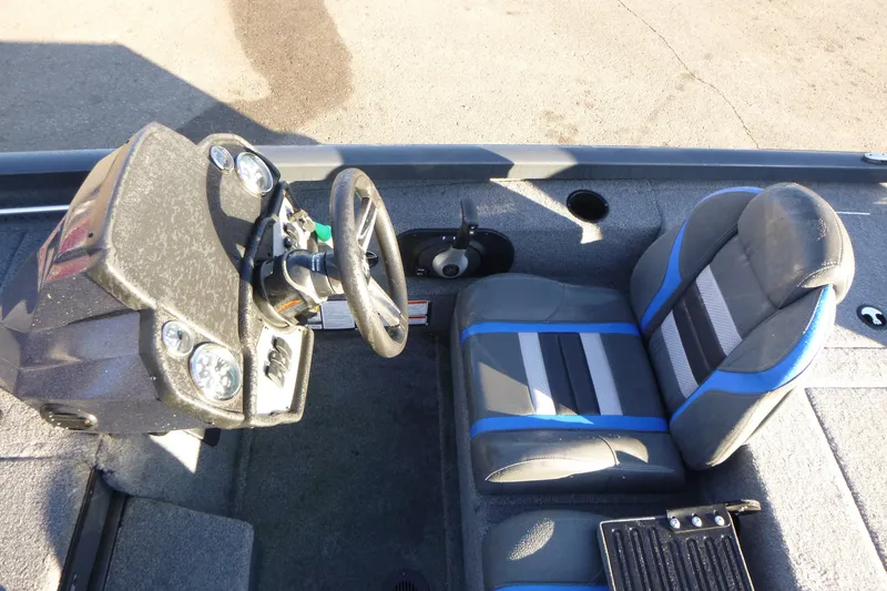 Slide: The Image of 2022 Ranger RT188P boat cockpit with steering wheel and blue-accented seat. - 6