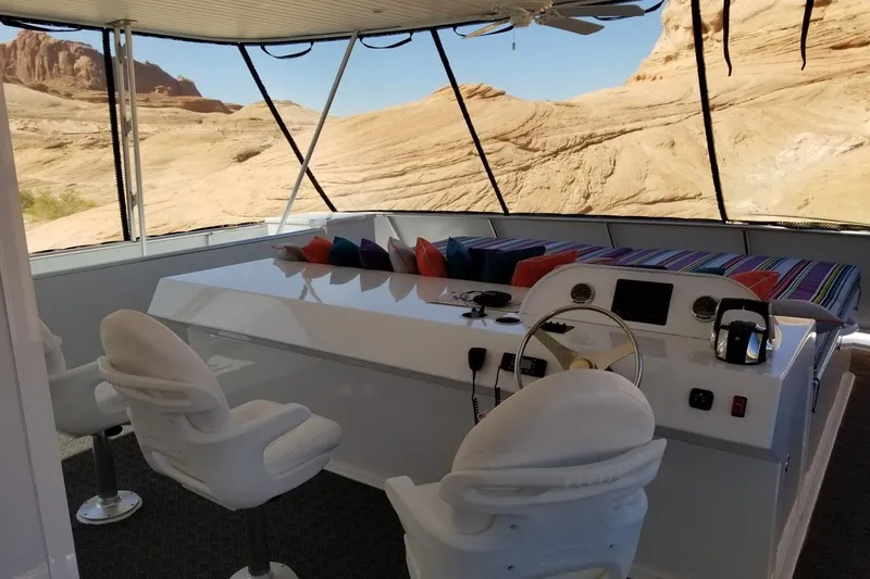 Slide: The Image of Luxurious Adonia 7518 houseboat interior with helm, seating, and scenic desert view, 2017 model. - 18